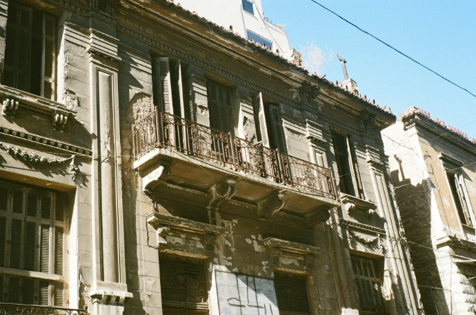an old building with a clock on the front of it